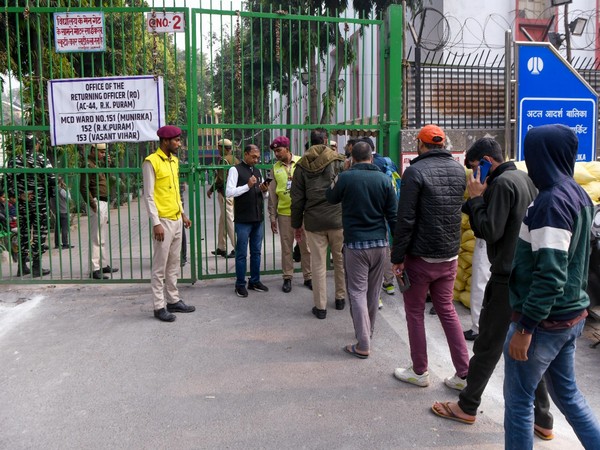 People in a queue to cast their vote at a polling booth in Delhi (Photo/ANI)