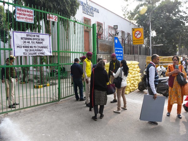 Polling officials come out of a polling booth (Photo:ANI)