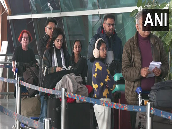 Passengers line up in a queue at Delhi airport on Tuesday. (Photo/ANI)) 