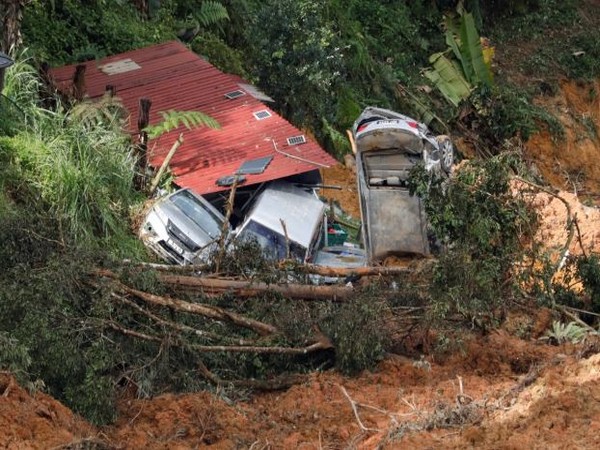 Damaged cars are seen amongst the debris during a rescue and evacuation operation following a landslide at a campsite in Batang Kali. (Photo Credit - Reuters)