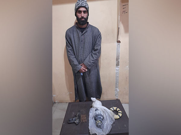 Arrested terrorist associate with recovered arms (Photo/ANI)