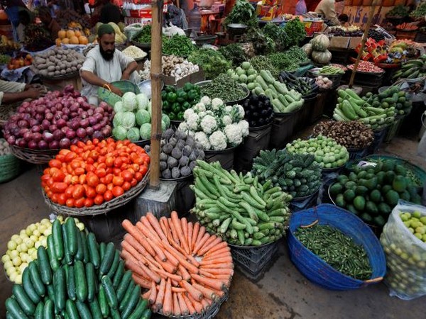 A vendor waits for customers to sell vegetables at a makeshift stall in a market, in Karachi. (Photo Credit - Reuters)