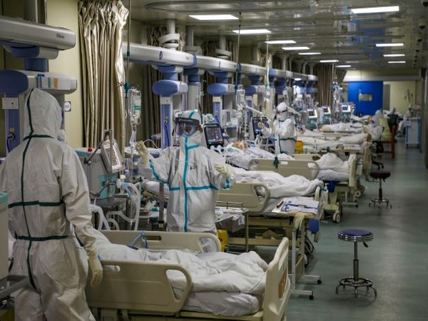 Medical workers in protective suits attend to novel coronavirus patients at the intensive care unit (ICU) of a designated hospital in Wuhan. (Photo Credit - Reuters)