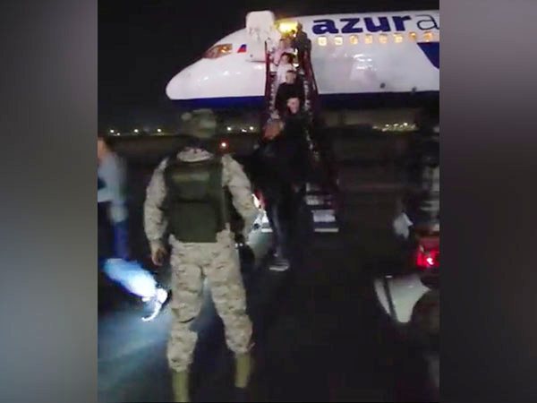 An IAF Garud Special Forces operative evacuating passengers from Azur Air aircraft at Jamnagar air base (Photo/ANI)