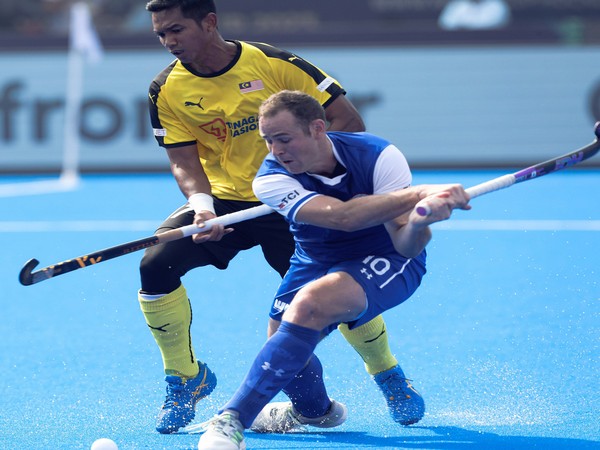 A Malaysian player vies for the ball with a Chilean opponent during the WC clash on Monday. (Photo- HI Twitter)