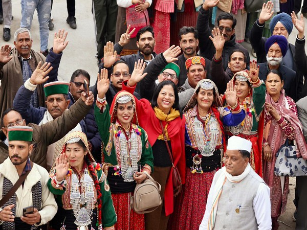 Artists dressed in traditional attire wave during Congress Bharat Jodo Yatra in Kangra (Photo/ANI)