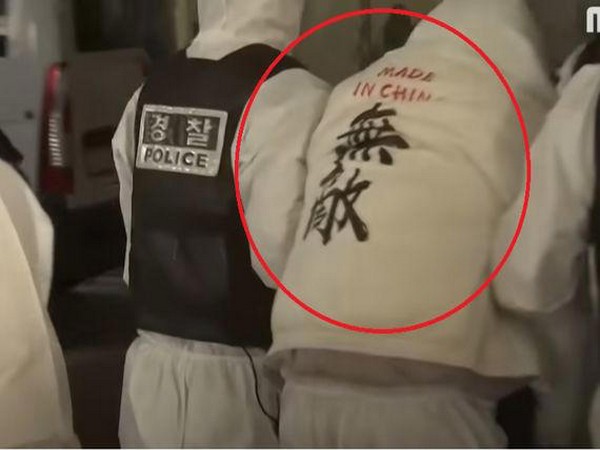 Chinese Covid-positive tourist with a 'Made in China: invincible' jacket. (Photo Credit - Twitter/Germs of Killer CCP)