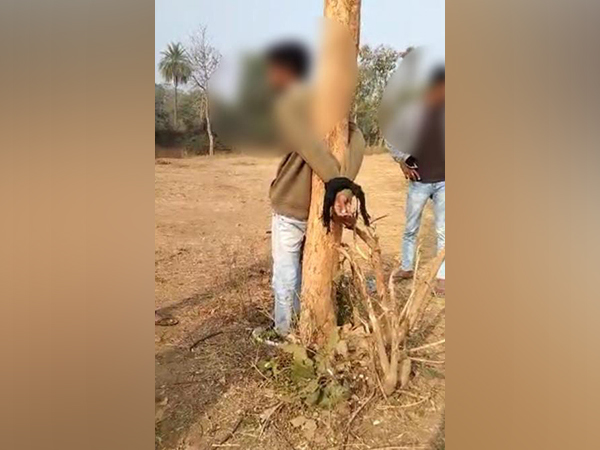 A clip from the viral video showing the youth tied to a tree. (ANI/Photo)