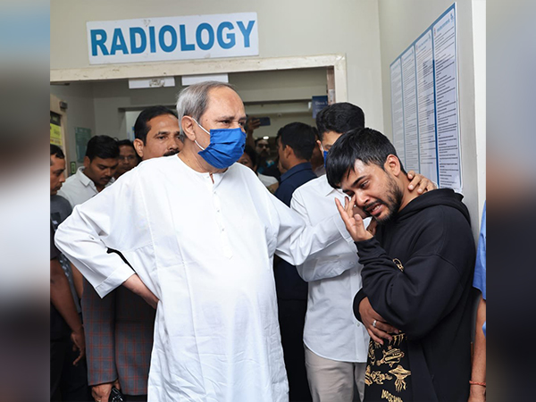 Odisha CM Naveen Patnaik consoles the son of Health Minister Naba Das (Photo:ANI)