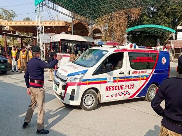 A police officer guides an ambulance after a suicide blast in a mosque in Peshawar. (Photo: Reuters)