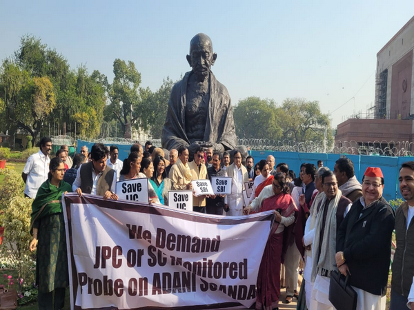 Opposition protests near Gandhi statue on Monday in the parliament house to demand probe into allegations against Adani (photo/ANI)