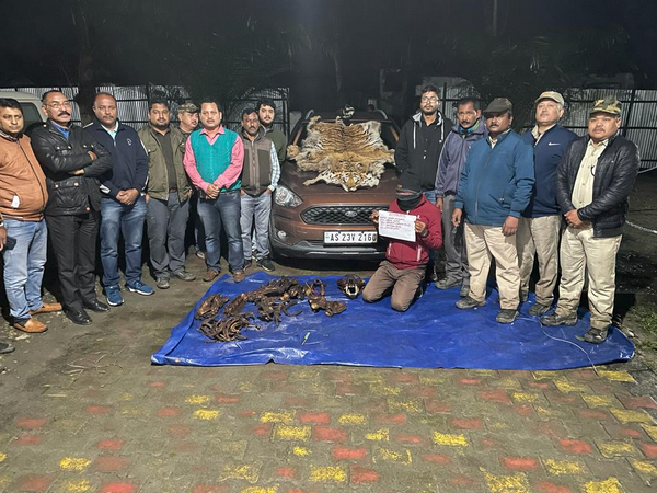 Assam Forest Department officials with the seized items (Photo/ANI)
