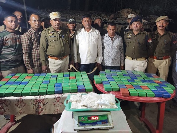 Assam Police officials with arrested peddlers and seized contraband