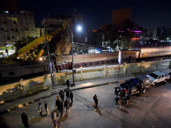 People gather on a bridge above  scene of a train crash in Qalyub in north of Cairo (Photo Credit: Reuters)