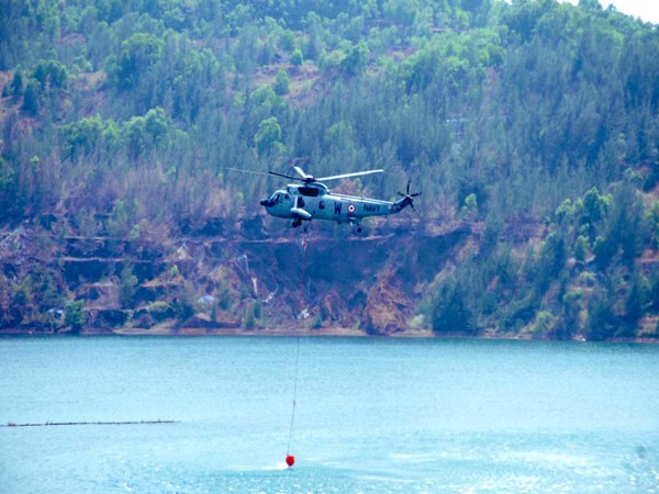 Indian Navy Helicopter conducting fire dousing operation (Photo Courtesy: Defence PRO Western  Naval Command)