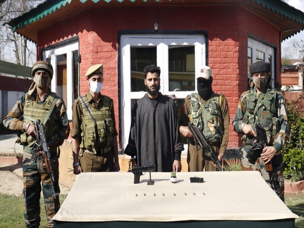 The arrested terrorist with Kashmir Police. (Photo/ANI)