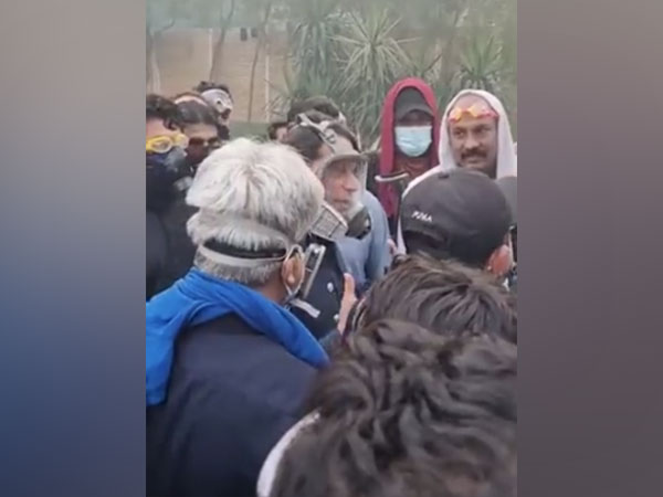 PTI chief Imran Khan in a gas mask interaction with his supporter's. (Photo Credit - Twitter/PTI)