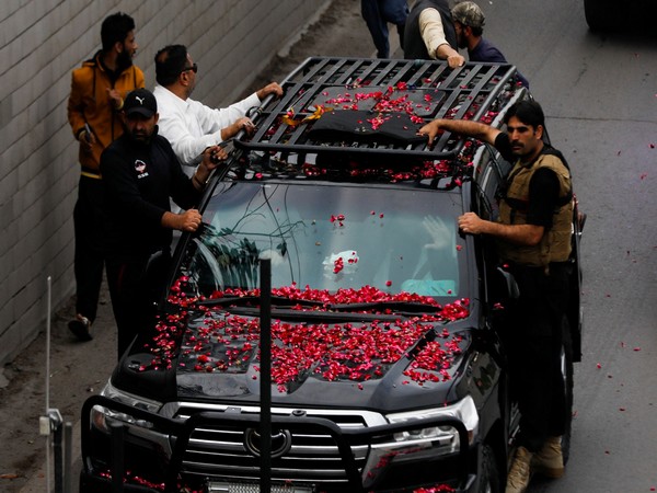 Former Pakistani Prime Minister Imran Khan, waves from the vehicle as he leaves from Lahore to appear before Islamabad High Court, in Lahore, Pakistan March 18, 2023. (Photo/Reuters)