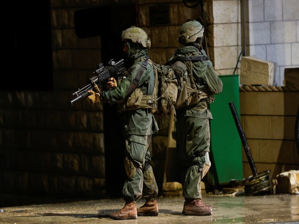 Israeli troops stand guard at the scene of a shooting, in Huwara (Image Credit: Reuters)