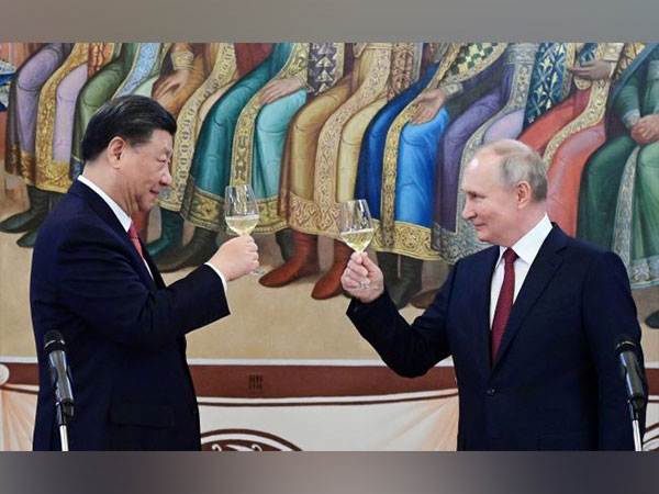 Russian President Vladimir Putin and Chinese President Xi Jinping attend a reception in Moscow. (Photo Credit - Reuters)