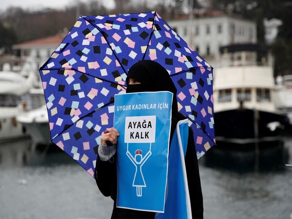 A woman from China's Uyghur Muslim ethnic group holds placard 