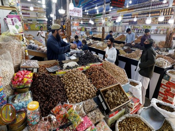People buy dry fruits at a market in Karachi. (Photo Credit - Reuters)
