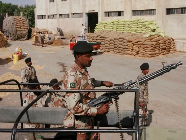 Paramilitary soldiers stand guard inside a flour mill in Karachi. (Photo Credit - Reuters)