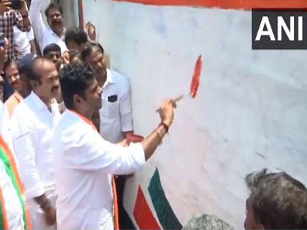 K Annamalai paints the party's lotus symbol on a wall (Photo\ANI)
