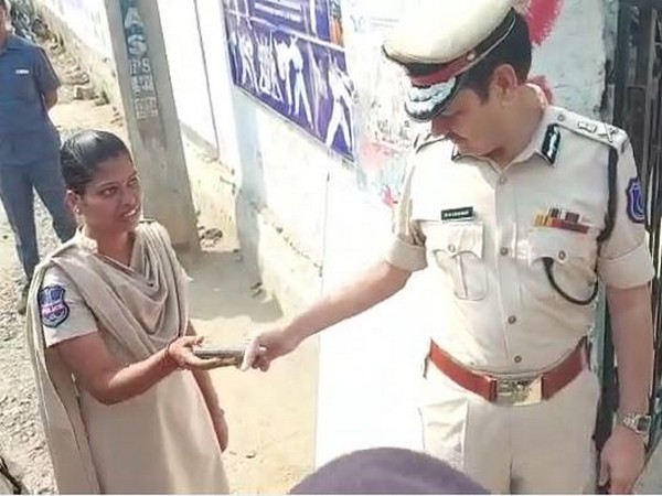    Commissioner of Police handing over mobile to constable ahead of entering examination center (Photo\ ANI)