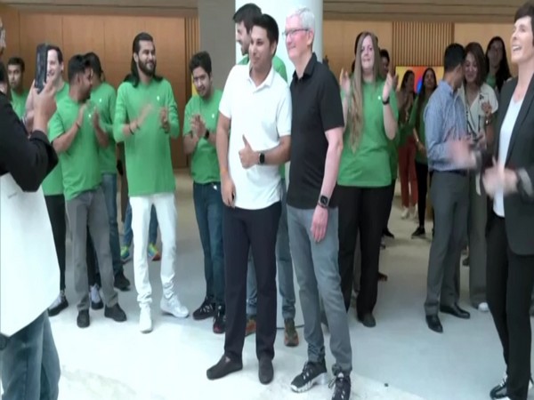 Fan posing with CEO Tim Cook after the inauguration (Photo/ANI)