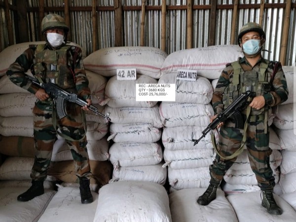 Assam Rifles personnel with the recovered Areca Nuts (Photo/ANI)