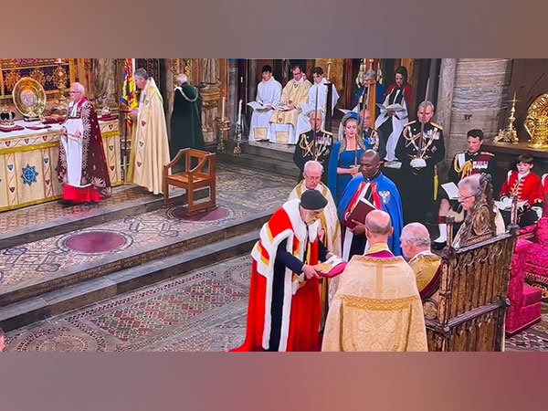 Lord Indarjit of Wimbeldon presents the Glove worn to hold the Sovereign's Sceptre at the Coronation. (Photo Credit - The Royal Family's Youtube)