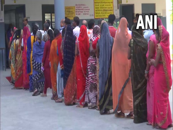 Voters queued up at a polling booth in Azamgarh (Photo/ANI)