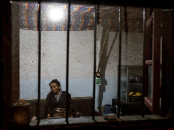 A woman sits in a noodle restaurant in the old city of Lhasa, Tibet. (Photo Credit: Reuters)