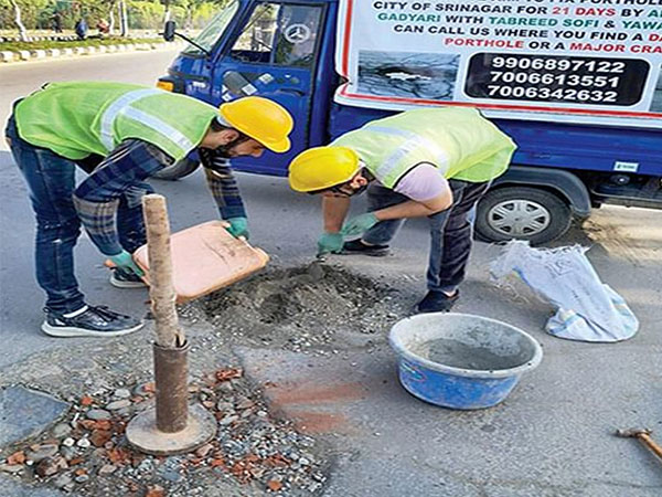 Youth fixing potholes in Downtown Srinagar