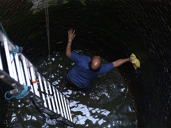 Newar community member cleaning well on the occasion of Sithi Nakha festival. (Photo/ANI)