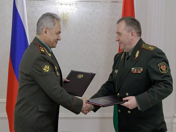 Russian Defence Minister Sergei Shoigu shakes hands with Belarusian Defence Minister Victor Khrenin (Image Credit: Reuters)