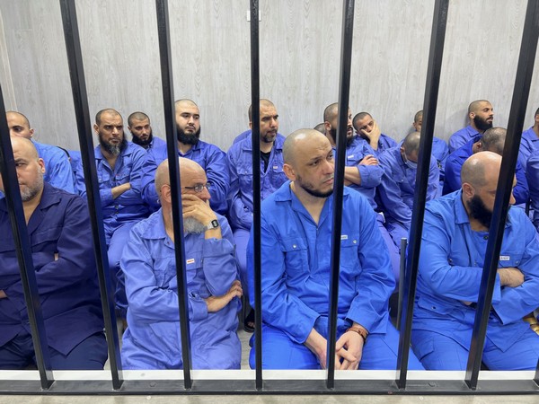 Suspects sit behind bars during a judgment sentence against 56 defendants accused of joining Islamic State group in the court in Misrata. (Photo Credit: Reuters)