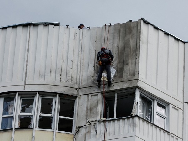 Workers repair damage on the roof of a multi-storey apartment block following a reported drone attack in Moscow. (Photo Credit: Reuters)