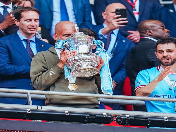 Pep Guardiola kissing the FA Cup trophy. (Photo- Manchester City Twitter)