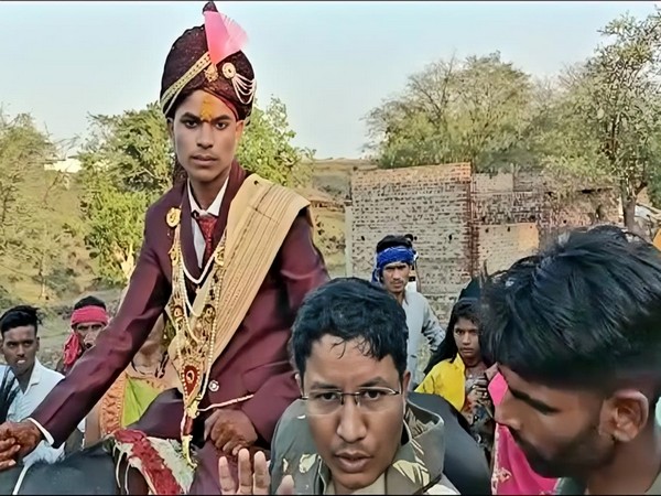 Groom sitting on mare (snap from the video shot by locals)