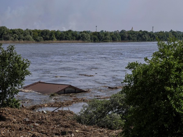 Roof of a house is seen in the Dnipro river which flooded after the Nova Kakhovka dam breached. (Photo/Reuters)