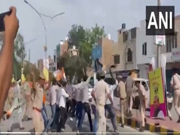 Police chase away Congress workers showing black flags to CM Arvind Kejriwal (Photo/ANI)
