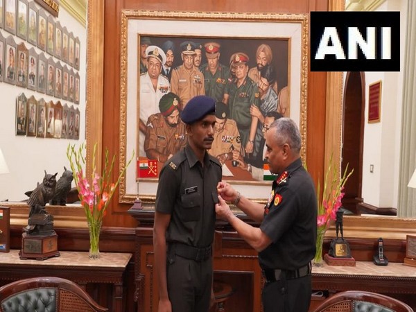 Chief of Army Staff, General Manoj Pande awards commendation card to Sepoy Navneetha Krishnan. (Photo/ANI)