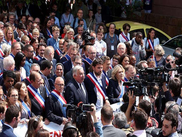 People march in support of French Mayor Vincent Jeanbrun (Source: Reuters Images)
