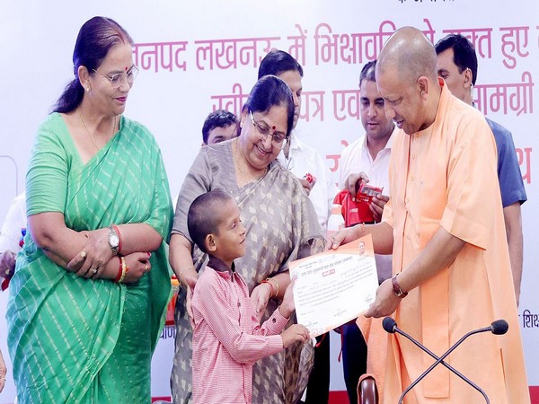 Uttar Pradesh Chief Minister Yogi Adityanath distributing certificates and kits to rescued children (Photo/ANI)