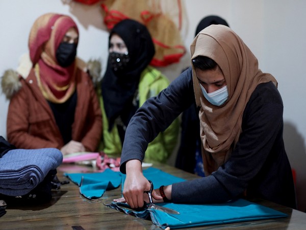 An Afghan woman cuts a fabric at a sewing workshop in Kabul. (Photo Credit - Reuters)