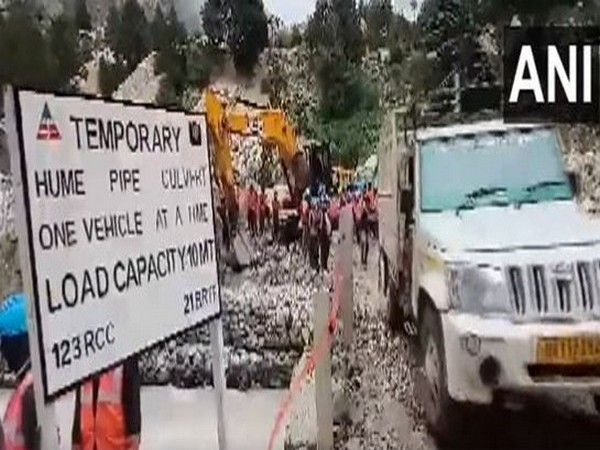 Traffic temporarily restored on a bridge washed away in landslides triggered by heavy rains on July 10 (Photo/ANI)