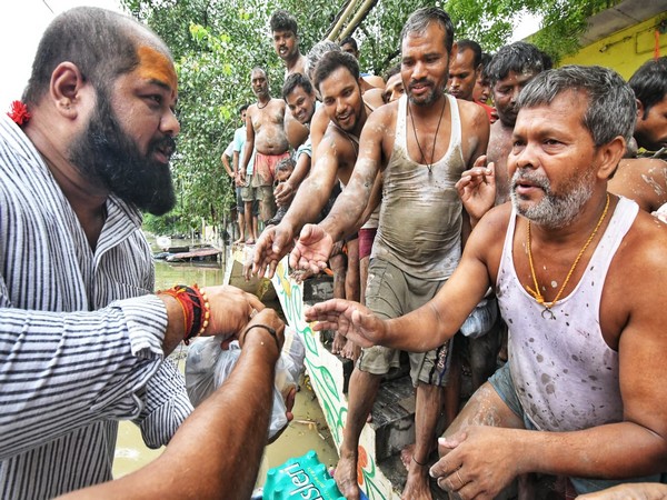 World champion powerlifter-turned-shooter Gaurav Sharma distributing food items to to flood-affected people