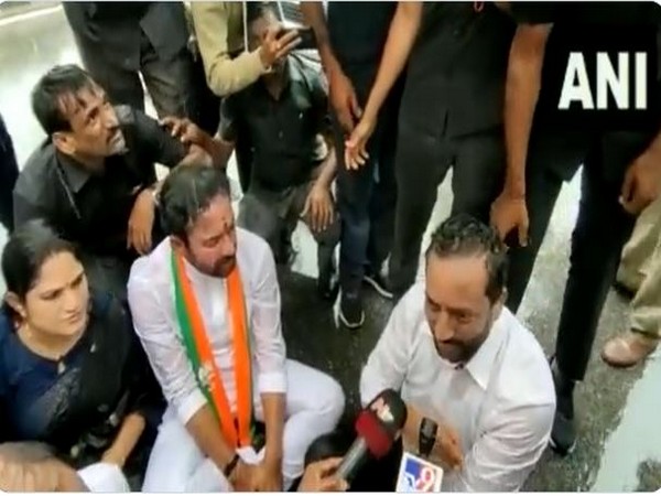 BJP president G Kishan Reddy sitting on road in protest amid a downpour at Shamshabad (Photo/ANI)